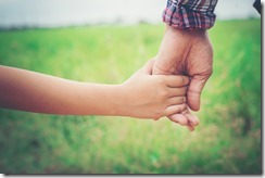 Close up of father holding his daughter hand, so sweet,family time.